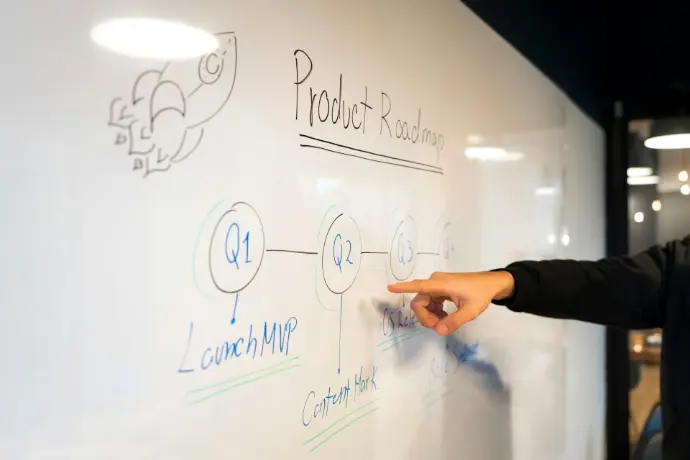 person writing on white board